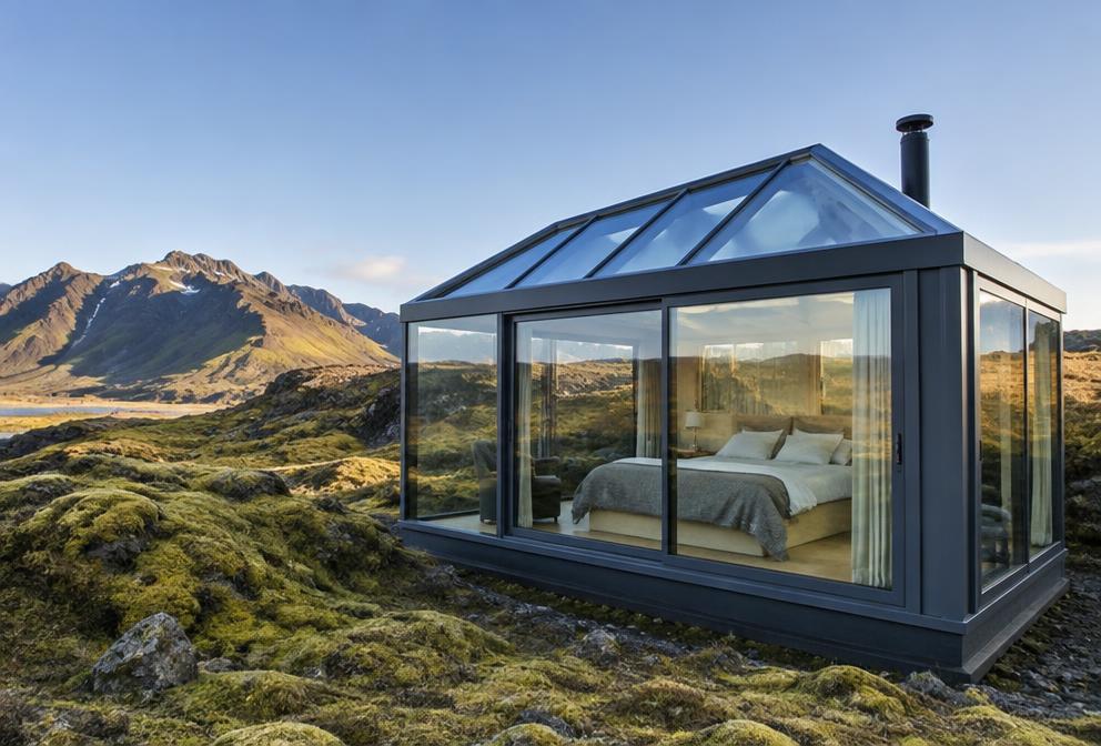 Illustration of a glass lodge in Iceland's volcanic landscape